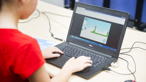 Matilda Bowen playing the game she made during the Code Camp at Holy Spirit Primary School.