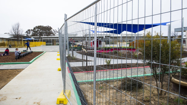 Temporary fencing around garden beds at Harrison School on Thursday. It is unclear whether this is one of the areas that contains non-friable asbestos.