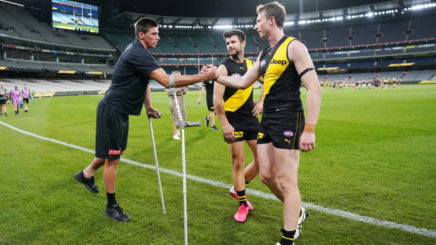 Get well soon: Tigers Dylan Grimes and Trent Cotchin (right) console injured Blue Matthew Kreuzer.