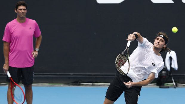 Philippoussis keeps a watchful eye on Tsitsipas at Melbourne Park.