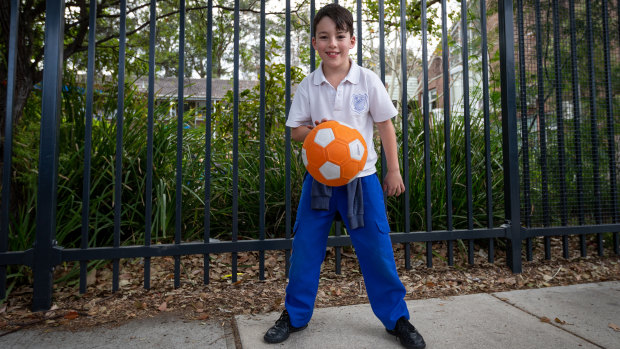 Nash Cazilieris plays with a ball that he'll no longer be allowed to bring to school.  