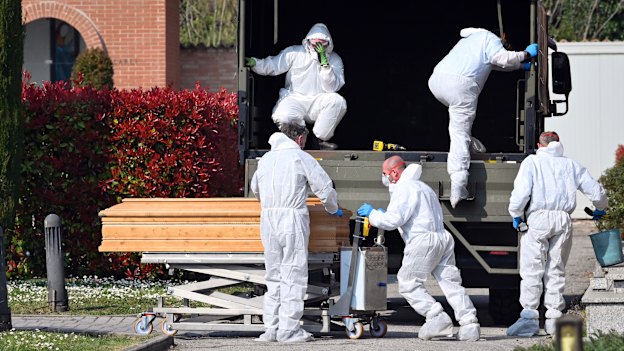 The Italian army unloads bodies at a  crematorium. 