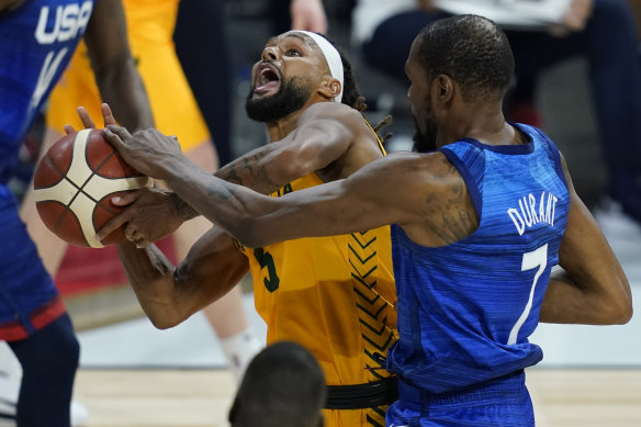 Patty Mills, who starred for the Boomers, is fouled by Kevin Durant.