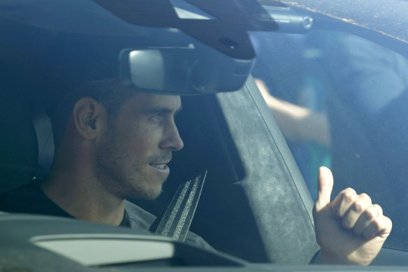 Gareth Bale gives fans the thumbs up as he arrives at Tottenham's training ground.