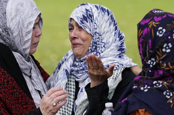 Mourners  cry at the grave of Wadea Al Fayoume in Illinois.
