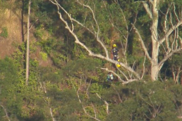 Emergency services rush to rescue a woman who had reportedly fallen about 30 metres down an embankment at Tamborine Mountain.