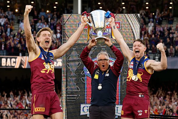 Two-time Brisbane Lions premiership coach Fagan (centre) with Harris Andrews and Lachie Neale after the 2025 grand final.