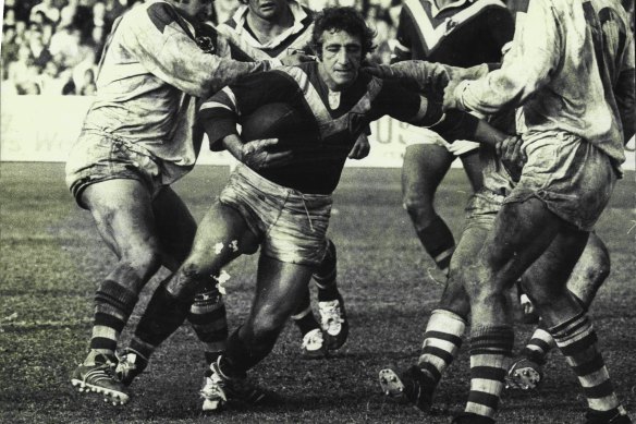 Eastern Suburbs second-rower Barry Reilly struggles to break the gasps of St. George defenders including Barry Beath (left) and Rod Reddy (No.10) Kevin Stevens and Jim Porter are in support in 1974.