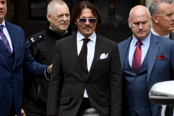 Johnny Depp, centre, leaves court in London on Friday.