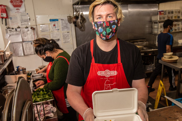 Luke Cornelissen with staff preparing take away and delivery meals at Thornbury Lentil  As Anything. 