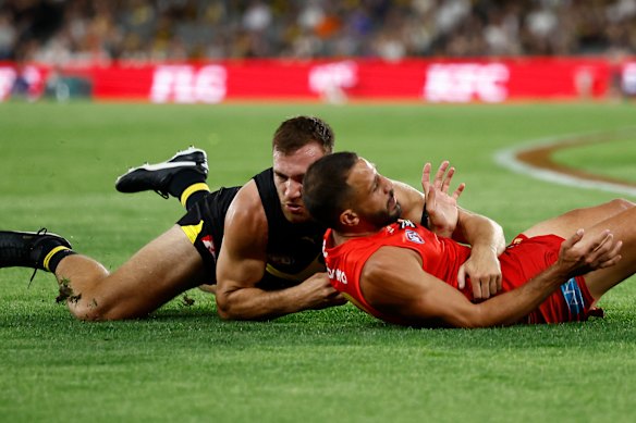 Noah Balta drags Suns forward Ben Long to the ground.