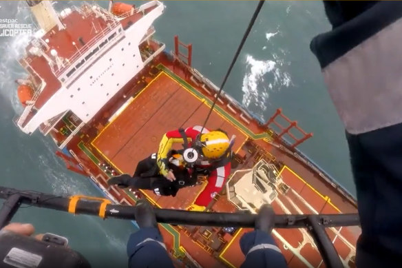 A rescue chopper attempts to reach crew on the Portland Bay cargo ship stranded off the Royal National Park.