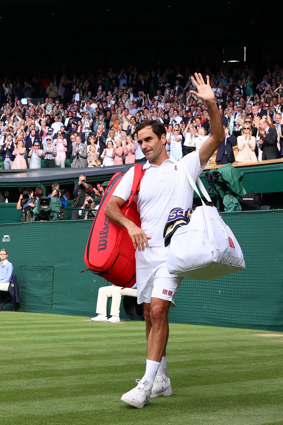 Federer waves to the Wimbledon crowd after being knocked out in the quarter-finals this year.