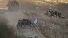 Israeli soldiers cross the security fence moving towards the so-called Alpha Line that separates the Israeli-annexed Golan Heights from Syria, in the town of Majdal Shams.