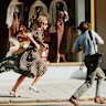 Diana runs from a pursuing photographer in 1997.