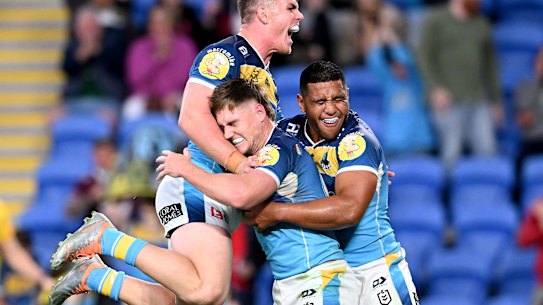 AJ Brimson (middle) celebrates with his Titans teammates.