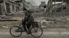 A man rides on a bike in a bombed-out part of Kurakhove, Donetsk region, Ukraine. 