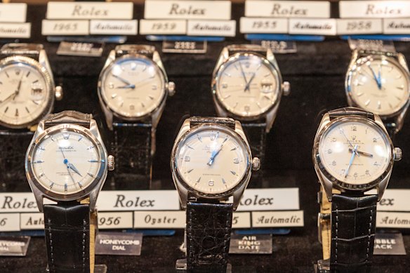 Vintage Rolex watches in shop display window.