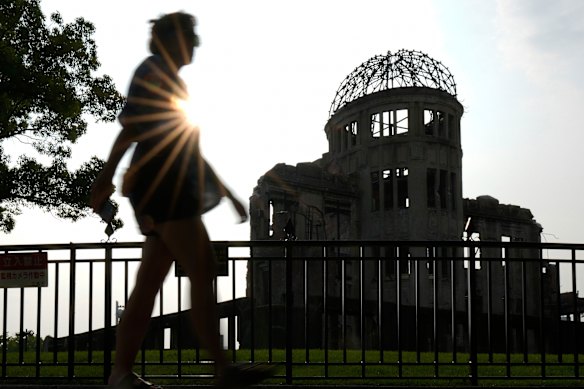 A visitor walks by the iconic exhibition hall best known as the Atomic Bomb Dome in Hiroshima, western Japan.