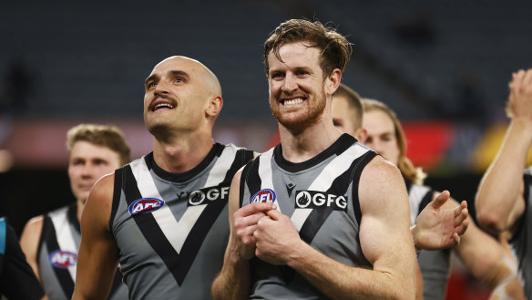 MELBOURNE, AUSTRALIA - AUGUST 14: Tom Jonas of the Power and Sam Powell-Pepper of the Power celebrate winning the round 22 AFL match between the Essendon Bombers and the Port Adelaide Power at Marvel Stadium on August 14, 2022 in Melbourne, Australia. (Photo by Daniel Pockett/Getty Images)