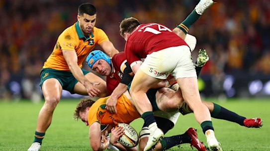 BRISBANE, AUSTRALIA - JULY 19: Harry Potter of the Wallabies is tackled by Tadhg Beirne and Tommy Freeman of the British and Irish Lions during game one of the series between Australia Wallabies and British & Irish Lions at Suncorp Stadium on July 19, 2025 in Brisbane, Australia. (Photo by Chris Hyde/Getty Images)