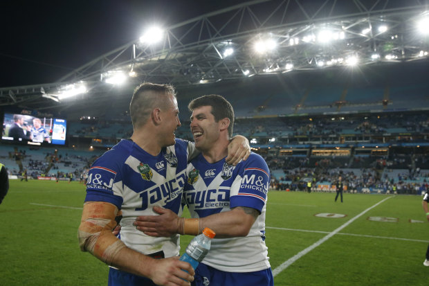 Josh Reynolds hugs Michael Ennis after what turned out to be his last game for the club, missing the 2014 grand final through injury.