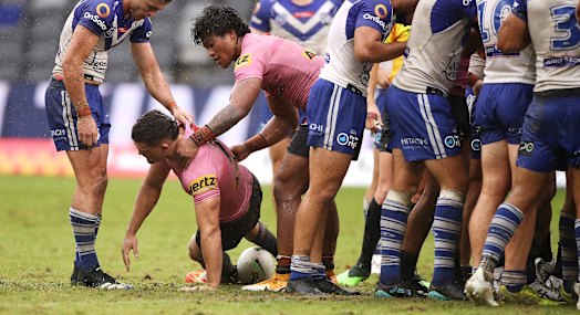 Nathan Cleary is helped to his feet after a careless high tackle by Dallin Watene-Zelezniak of the Bulldogs a fortnight ago.