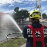 Ongoing battle: Firefighters battle the blaze at Rent A Space in Brookvale. 