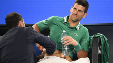 Novak Djokovic receives medical treatment during his third-round match at the Australian Open last year.