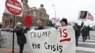 Protesters carry a sign in downtown Fort Worth, Texas, on Monday, Presidents' Day.