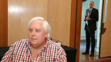 Ben Oquist hovers at a joint Clive Palmer-John Hewson press conference in 2014.