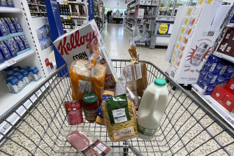 Less for more: A small selection of essential items sits in a shopping trolley in Northwich, England.