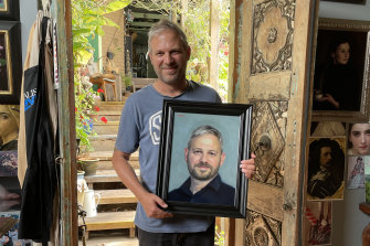 Brett Sutton holding a study of him by Vicki Sullivan, in the leadup to her painting him for the Archibald.