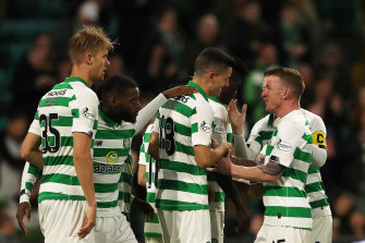 Tom Rogic (centre) celebrates scoring Celtic's second goal against Partick Thistle.