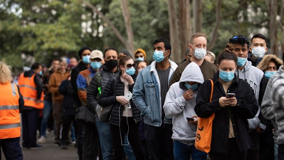 People queue up to receive COVID-19 vaccinations at Sydney Olympic Park.