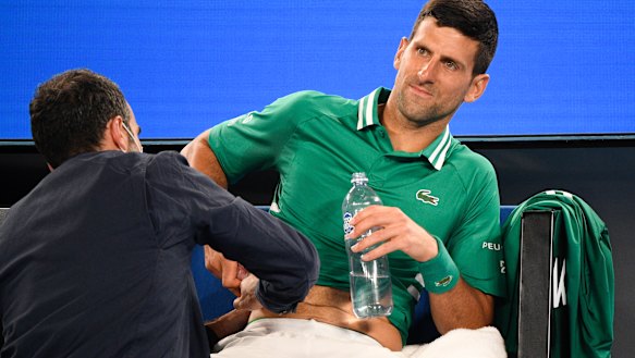 Novak Djokovic receives medical treatment during his third-round match at the Australian Open last year.