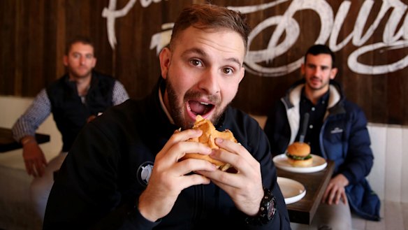Vegan Josh Berki bites into a meat-free, plant based, hamburger at Soul Burger in Randwick.