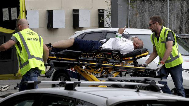 Ambulance staff take an injured man from a mosque in central Christchurch, New Zealand, after the mosque terror attacks on March 15.