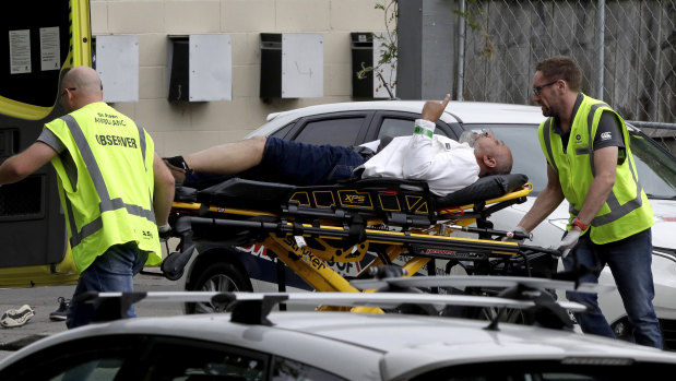 Ambulance staff take an injured man from a mosque in central Christchurch, New Zealand, after the attacks on March 15.