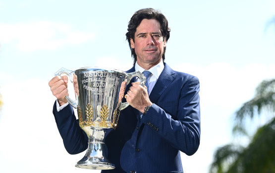 AFL chief executive Gillon McLachlan with the premiership trophy at the news conference announcing the grand final move to Queensland  on Wednesday.
