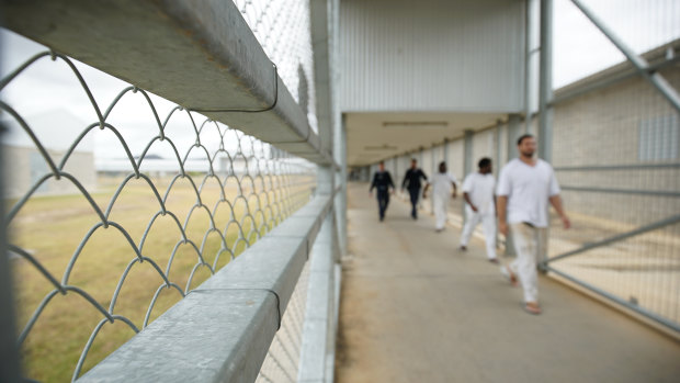Staff escorting prisoners through Lotus Glen Correctional Centre.