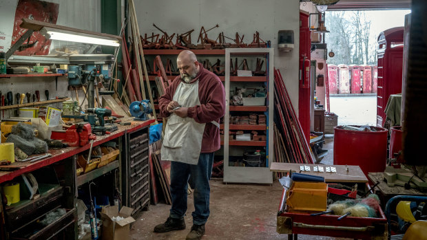 Tony Inglis at a workshop where he restores the iconic phone boxes.