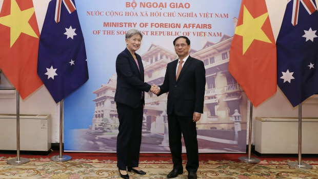 Penny Wong shakes hands with Vietnamese Foreign Minister Bui Thanh Son in Hanoi on Monday.