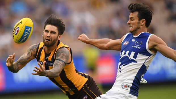 Outmanoeuvred: Hawk Chad Wingard gets in position ahead of North Melbourne's Robbie Tarrant.