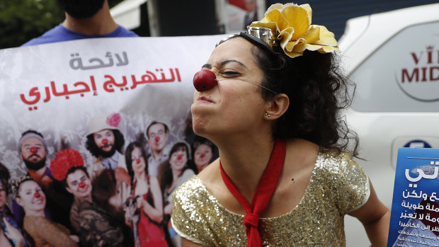 A member of the clown troupe, Clown Me In, pokes fun at Lebanon's first national elections in nine years, outside a ballot station in Beirut on Sunday.