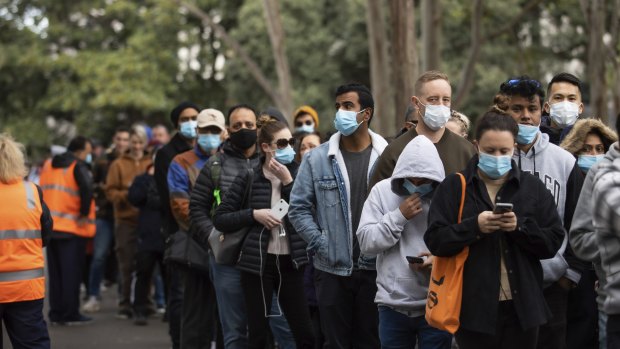 People queue up to receive COVID-19 vaccinations at Sydney Olympic Park.