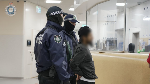 Neil Prakash is escorted by Australian Federal Police officers in Darwin.