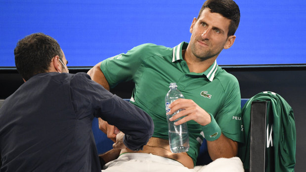 Novak Djokovic receives medical treatment during his third-round match at the Australian Open last year.