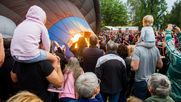 Despite hot air balloons being grounded by the weather on Saturday, crowds at the Canberra Balloon Spectacular stayed to see them inflated.