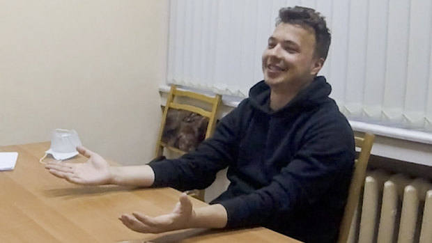 Dissident blogger Raman Pratasevich smiles in a video confession which opposition figures say is coerced. 